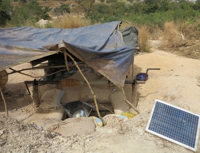 A mining pit in Burkina Faso that is covered with a tarp and connected to a solar panel.